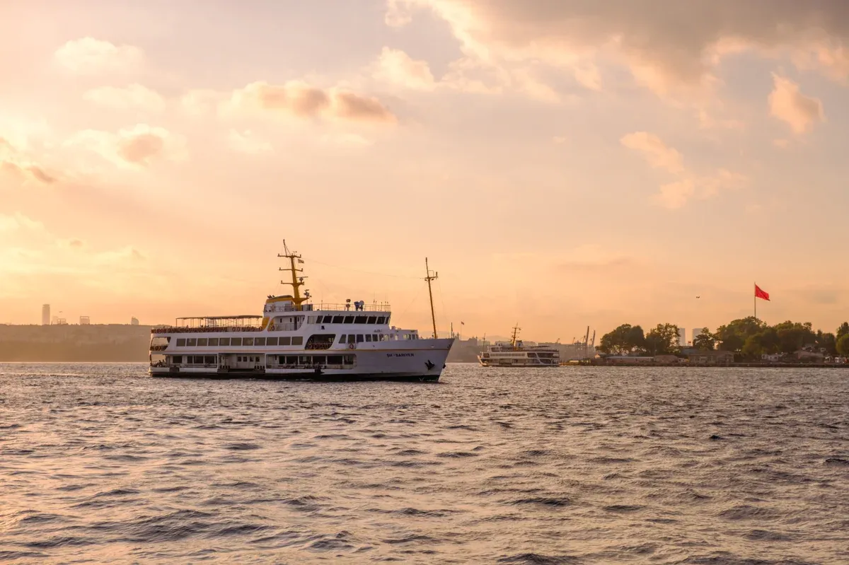 A city ferry crossing the Bosphorus at sunset in Istanbul, a stop on a Turkey itinerary
